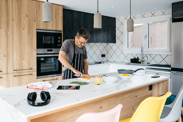 Man cutting vegetable in kitchen at home