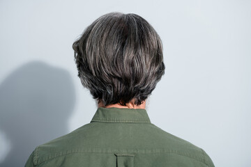 Rear back behind view portrait of attractive grey-haired man grooming hairdo styling isolated over...