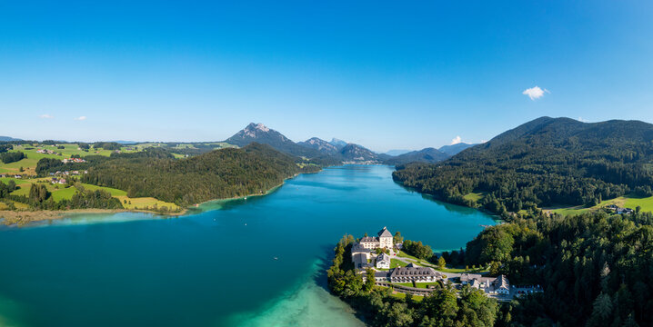 Austria, Salzburg, Hof bei Salzburg, Drone panorama of Lake Fuschl and Schloss Fuschl in summer