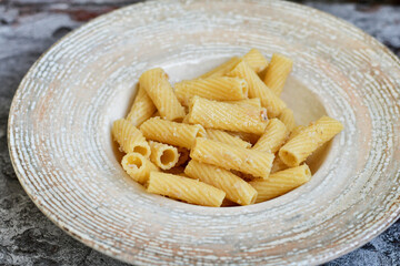  Italian home made  rigatoni   pasta  with  tuna  fish, parmesan cheese and black pepper .