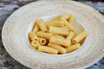  Italian home made  rigatoni   pasta  with  tuna  fish, parmesan cheese and black pepper .