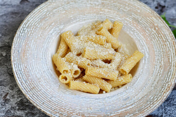  Italian home made  rigatoni   pasta  with  tuna  fish, parmesan cheese and black pepper .