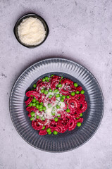 Fototapeta premium Beetroot pasta with green peas
