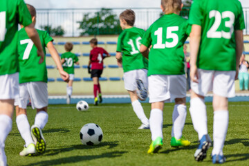 Football Class For Youth. Soccer Training With Coach For School Boys. Sporty Boys Running With Balls During Exercises. Ball Control Training