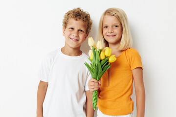 Portrait of cute children holiday friendship with a gift Yellow flowers lifestyle unaltered