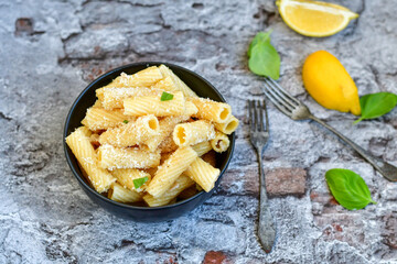  Italian home made  rigatoni   pasta  with  tuna  fish, parmesan cheese and black pepper .