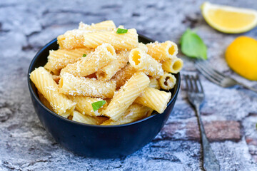  Italian home made  rigatoni   pasta  with  tuna  fish, parmesan cheese and black pepper .