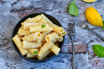  Italian home made  rigatoni   pasta  with  tuna  fish, parmesan cheese and black pepper .