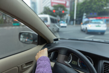 Fototapeta na wymiar People driving car on city road
