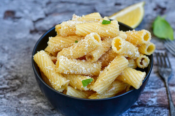  Italian home made  rigatoni   pasta  with  tuna  fish, parmesan cheese and black pepper .