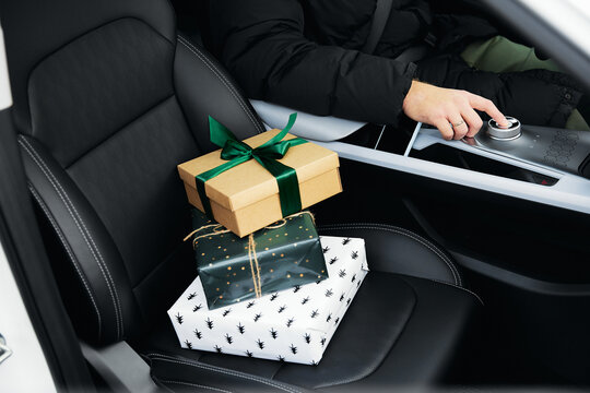 small gift boxes stand on the front seat of the car