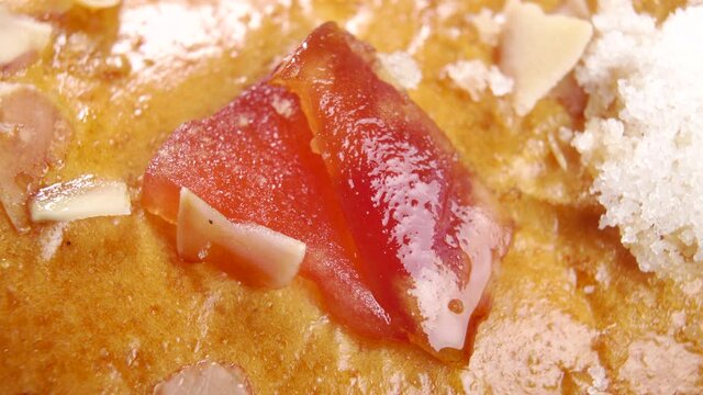 Traditional Spanish Epiphany cake. Festive Roscon de reyes. Kings cake candied surface. Typical Christmas dessert. Macro. Rotation. Fruits, sugar and nuts