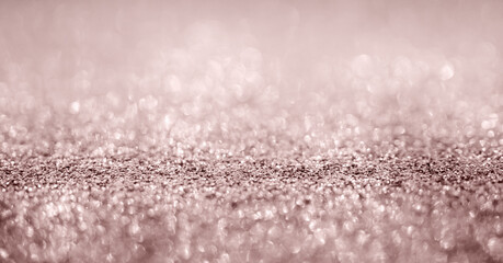 Abstract rose gold glitter sparkle texture with bokeh background