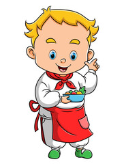 The little chef boy is cooking the vegetables in the kitchen