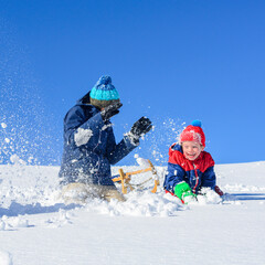 Mutter und Sohn genießen den frischen Pulverschnee an einem sonnigen Wintertag