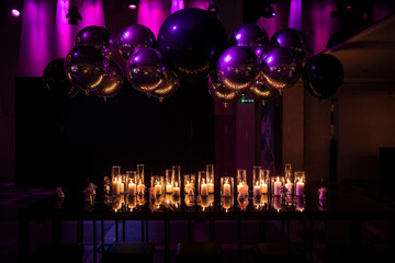 Glass jar's with burning candles light the room, making romantic and warm atmosphere at gala...