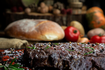 Beef steak seasoned with salt, pepper and fresh hearbs searved in the kitchen