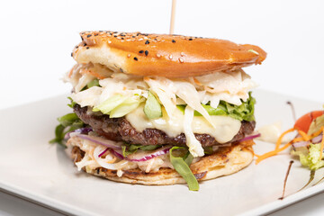 details of tasty beef burger with coleslaw salad on white background