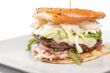 details of tasty beef burger with coleslaw salad on white background