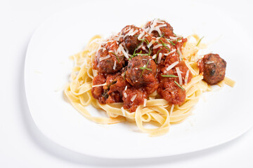 details of tasty fresh spaghetti and meatballs plate, on white background
