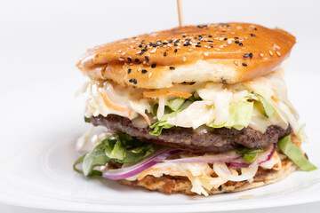 details of tasty beef burger with coleslaw salad on white background