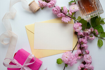 Obraz na płótnie Canvas card invitation in envelope with pink spring flowers. sakura. almond flowers