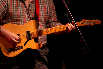 Obraz na płótnie Canvas Guitarists playing electric guitars on stage