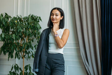 young Asian girl business style clothes, with a laptop