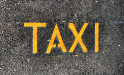 Taxi parking place on a street. Taxi sign symbol on new asphalt.