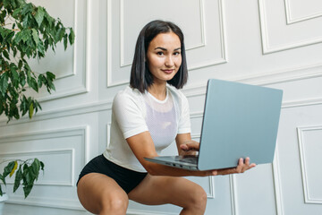 a young Asian girl is broadcasting from home. fitness classes