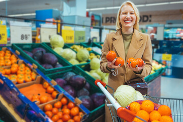 A young woman, housewife, go to the supermarket and buy groceries for his family. Woman cook breakfast, lunch, dinner and everything she wrote on her shopping list. She chooses, fruits