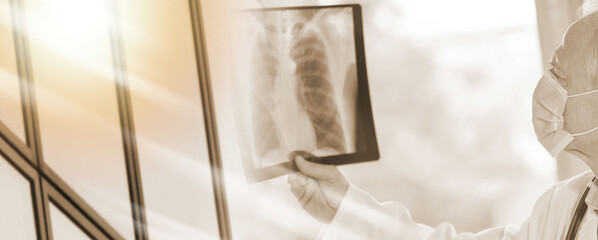 Obraz na płótnie Canvas Doctor examining lungs x-ray during coronavirus outbreak; multiple exposure