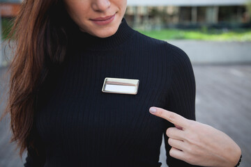 Closeup of a business woman pointing at an identification card