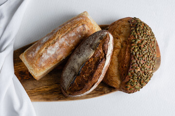 Rye bread on a board on a white tablecloth background