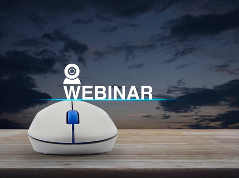 Webinar flat icon with wireless computer mouse on wooden table over sunset sky, Business seminar online concept