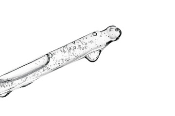 Transparent pipette with cosmetics on a white isolated background.