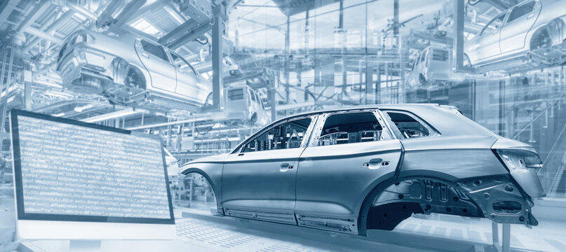 Production in the automotive industry with assembly lines, car bodies and screen with program code