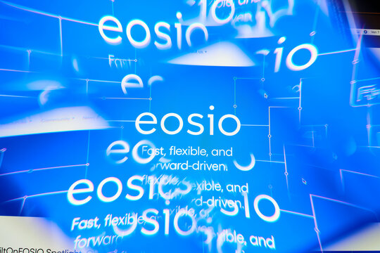 Milan, Italy - January 11, 2022: eos - EOS logo on laptop screen seen through an optical prism. Dynamic and unique image form eos, EOS coin website. Illustrative editorial.