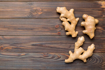 Finely dry Ginger powder in bowl with green leaves isolated on colored background. top view flat lay