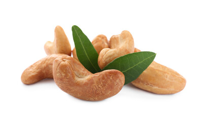 Pile of tasty organic cashew nuts and green leaves isolated on white