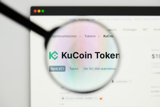 Milan, Italy - January 11, 2022: kucoin token - KCS website's hp.  kucoin token, KCS coin logo visible through a loope. Defi, ntf, cryptocurrency concepts illustrative editorial.