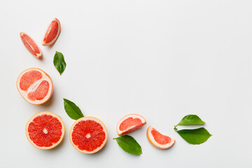 fresh Fruit grapefruit with Juicy grapefruit slices on colored background. Top view. Copy Space. creative summer concept. Half of citrus in minimal flat lay with copy space