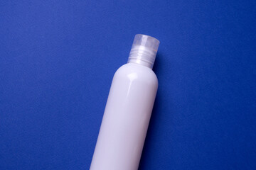 shampoo or hair conditioner bottle isolated on blue background