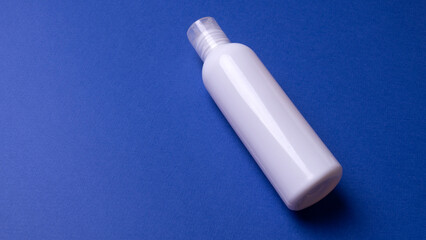 shampoo or hair conditioner bottle isolated on blue background