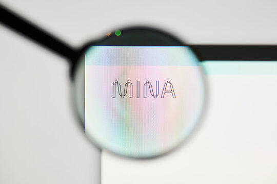 Milan, Italy - January 11, 2022: mina protocol - MINA website's hp.  mina protocol, MINA coin logo visible through a loope. Defi, ntf, cryptocurrency concepts illustrative editorial.