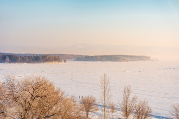 Winter frosty landscape on the Volga river with a beautiful sky. Top view, soft focus