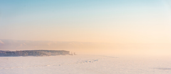 Winter frosty landscape on the Volga river with a beautiful sky. Top view, soft focus