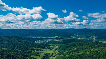 Fototapeta na wymiar mountains aerial view in blue sky clouds