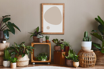 Obraz na płótnie Canvas Stylish botany composition of home garden interior with wooden mock up poster frame, filled a lot of beautiful house plants, cacti, succulents in different design pots and floral accessories. Template
