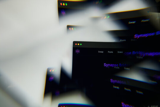 Milan, Italy - January 11, 2022: synapse - SYN logo on laptop screen seen through an optical prism. Dynamic and unique image form synapse, SYN coin website. Illustrative editorial.